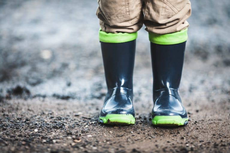 Toddler wearing rubber boots in rainy weather