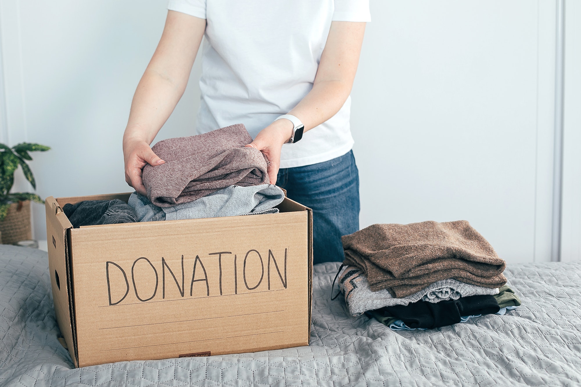 https://smoothmoveremovals.com.au/wp-content/uploads/2021/08/donation-concept-young-woman-in-white-t-shirt-with-donation-box-at-home-woman-donates-clothes.jpg